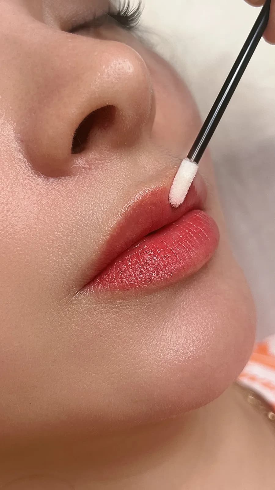 Applying aftercare after a lip treatment