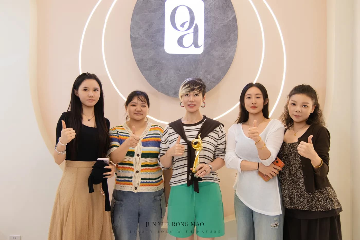 Lina Liu holding the gold trophy with her training group