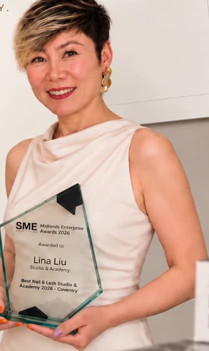 Lina Liu holding the SME News Midlands Enterprise Awards 2026 glass award